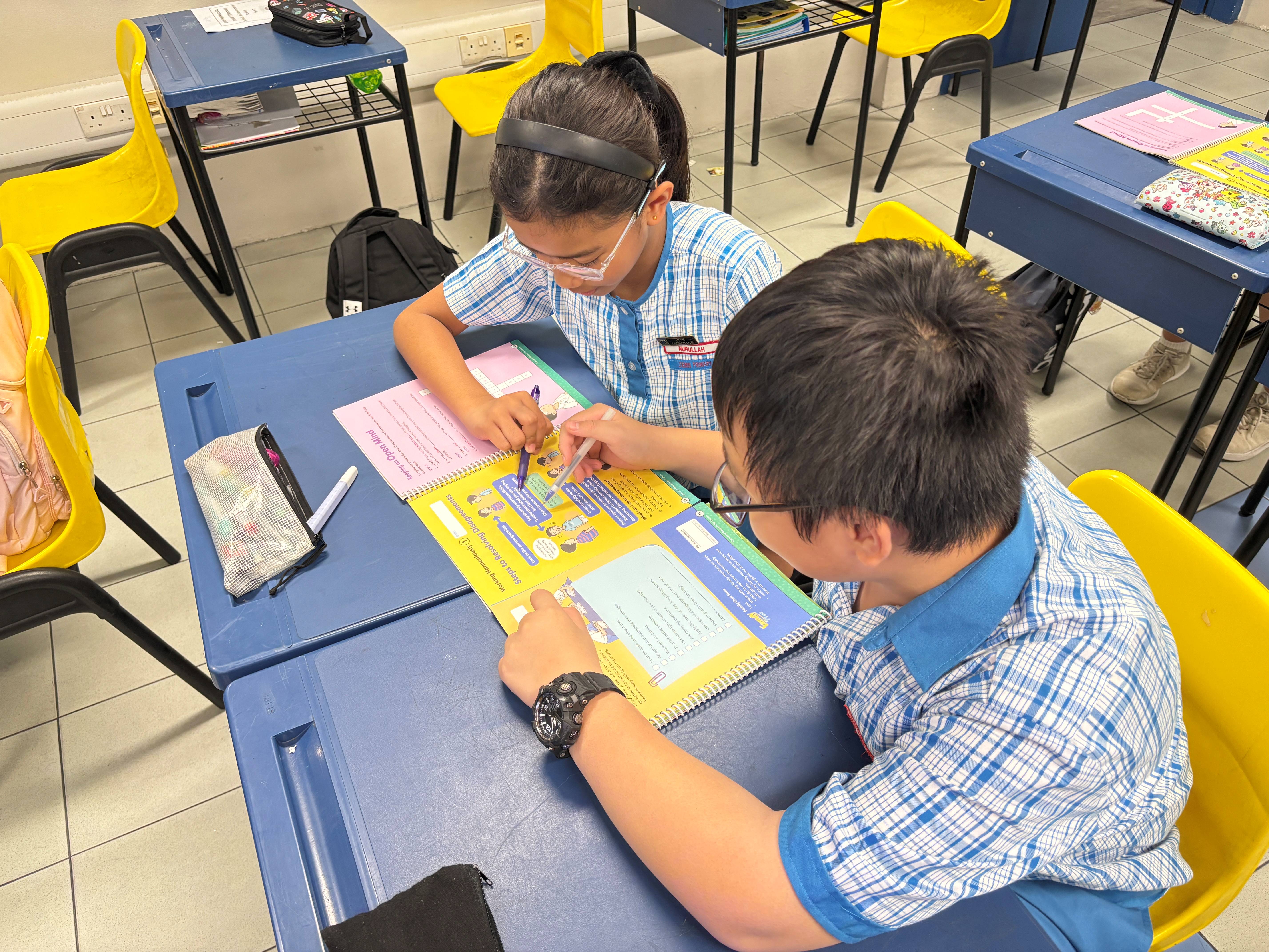 An Image showing 2 pupils discussing the activity in their FTGP journals.