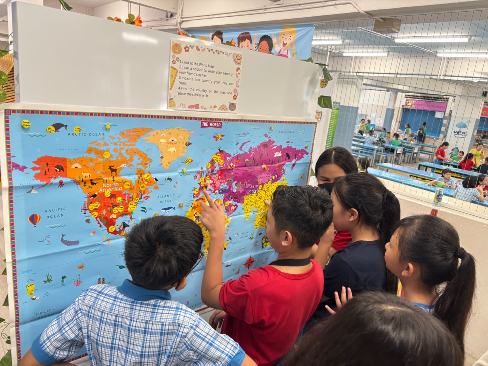 A group of students looking at the world map to identify ASEAN countries.