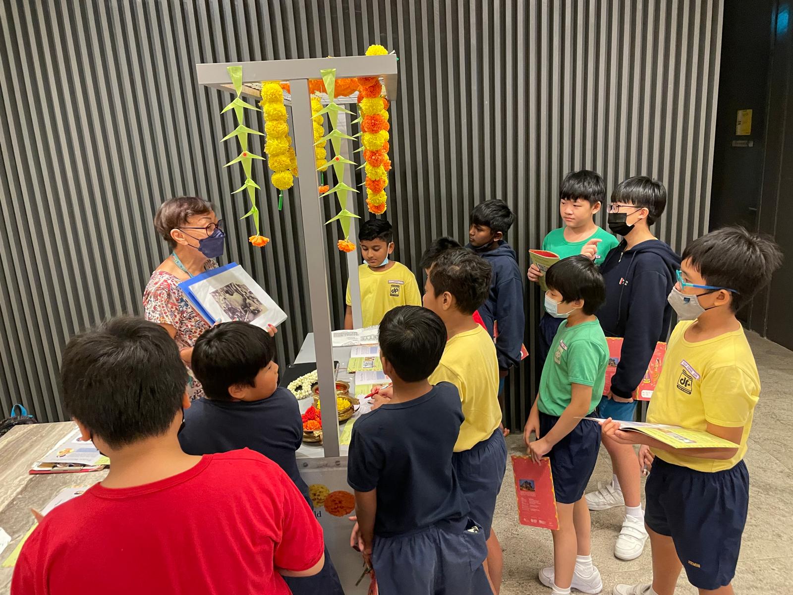 A group of students listening to the staff at Indian Heritage Gallery.