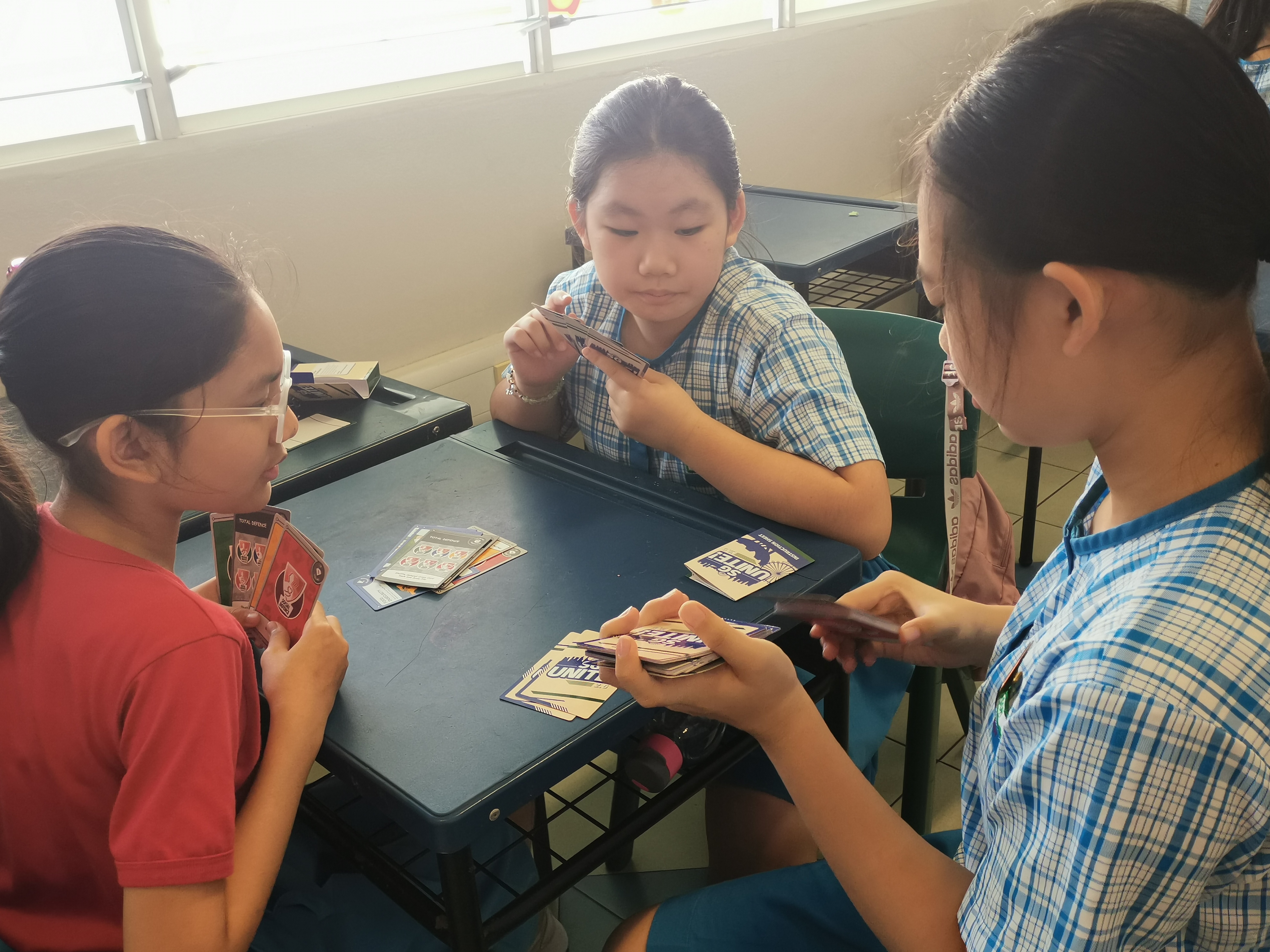 A group of pupils playing Total Defence Card.